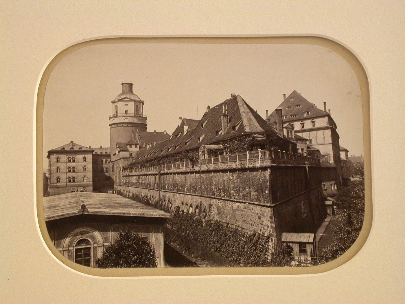 Strangely angled view of large fortified ? building with round tower in background, Leipzig, Germany