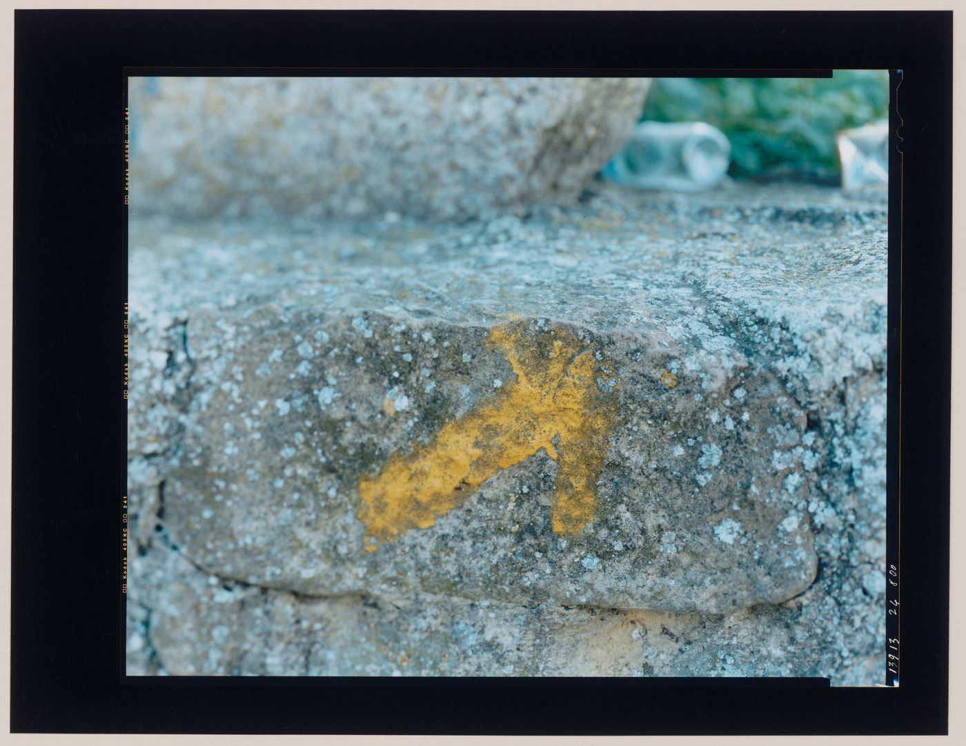 Close-up view of a stone wall bearing a painted arrow showing rubbish, Puente la Reina, Spain (from the series "In between cities")