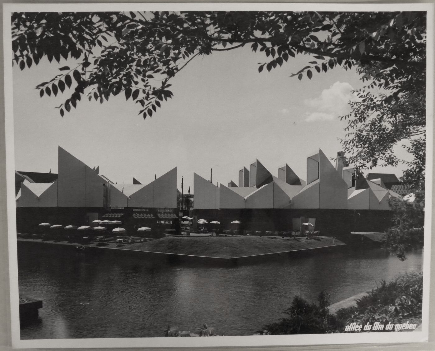 View of a terrace with tables behind the Africa Place, Expo 67, Montréal, Québec