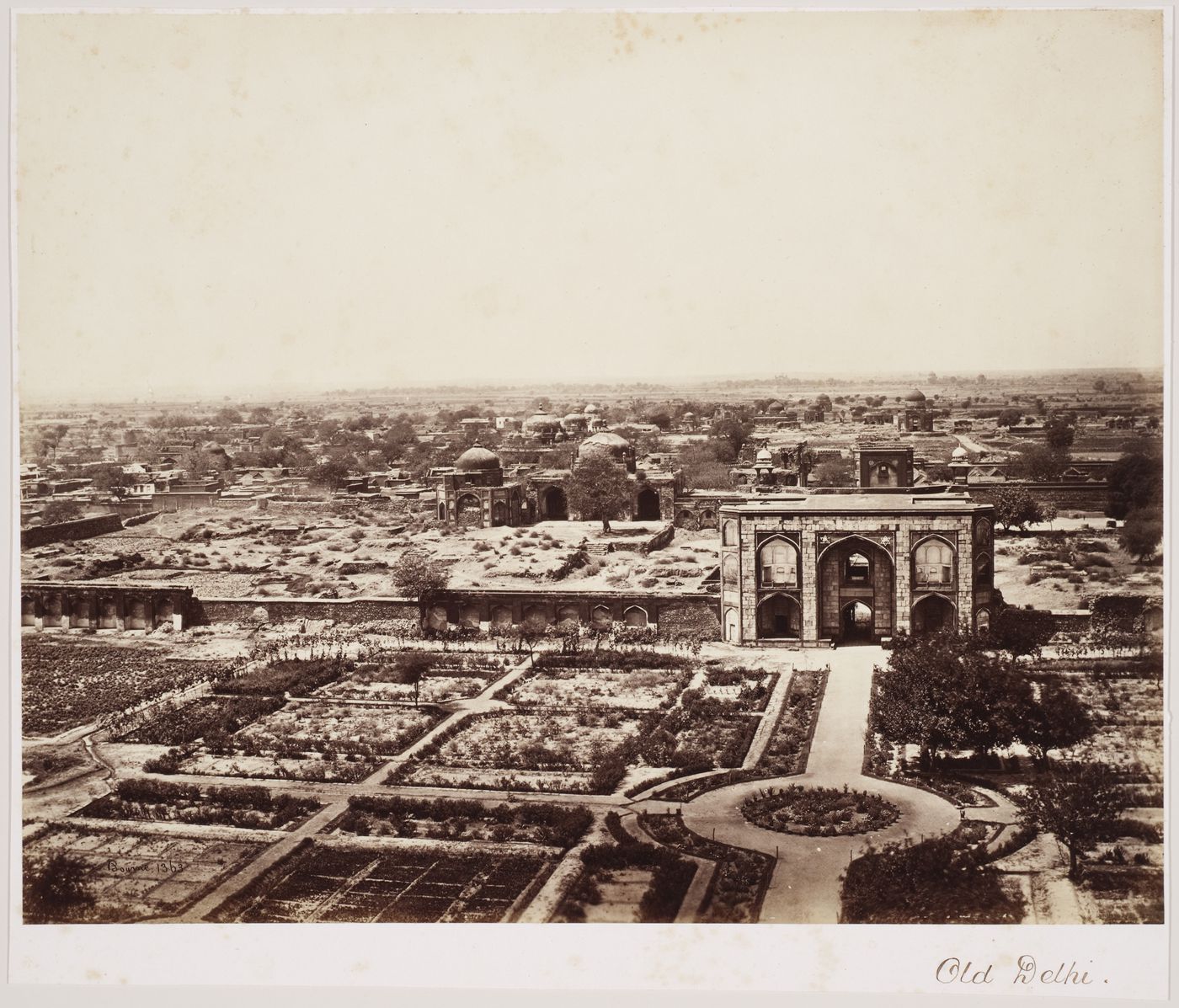 View showing a gateway, the remains of fortifications, and formal gardens in the foreground, Delhi, India
