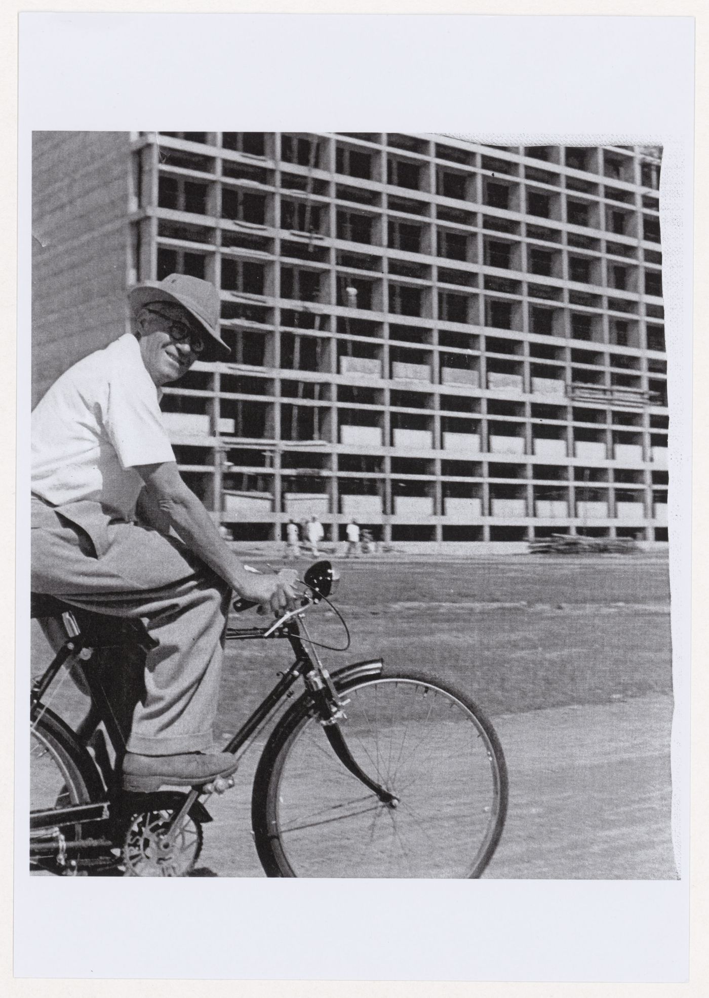 Portrait of Pierre Jeanneret on bicycle near the Secretariat under construction, Capitol Complex, Sector 1, Chandigarh, India