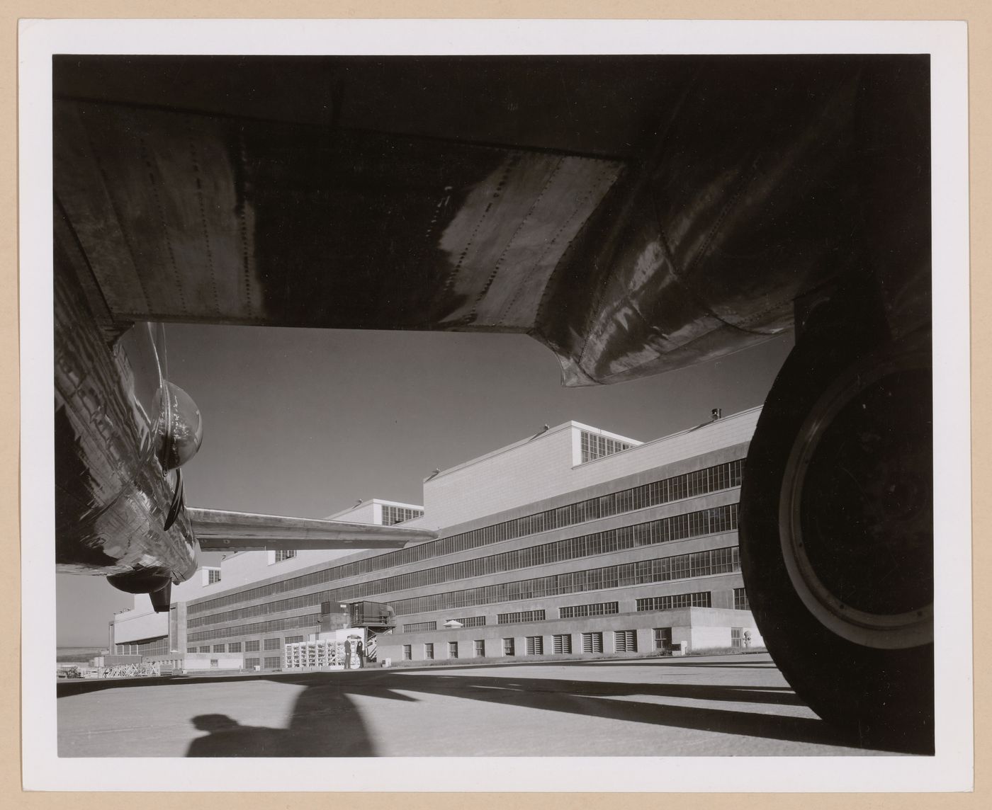 View of the rear [?] façade of the Manufacturing Building from beneath an airplane wing, Glenn L. Martin Company Bomber Plant, Omaha, Nebraska