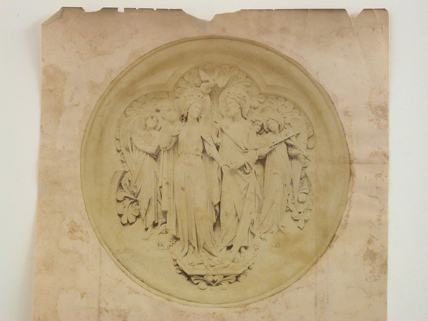 Close-up view of a circular relief panel depicting religious figures, England