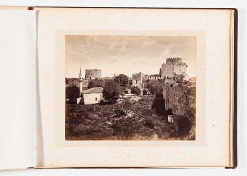View of a section of the Theodosian Wall showing wall towers, a gate, buildings and a minaret, Constantinople (now Istanbul), Ottoman Empire (now in Turkey)