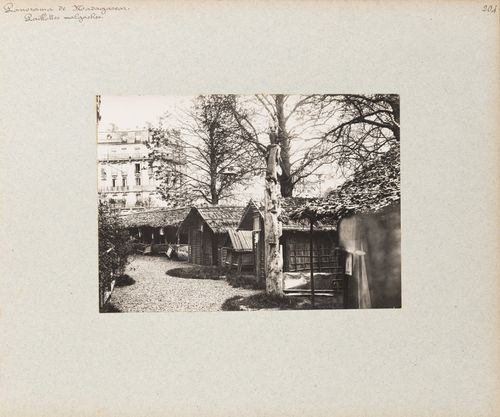 View of Malagasy houses with thatched roofs on grounds of Pavillon de Madagascar, Exposition universelle, 1900, Paris, France