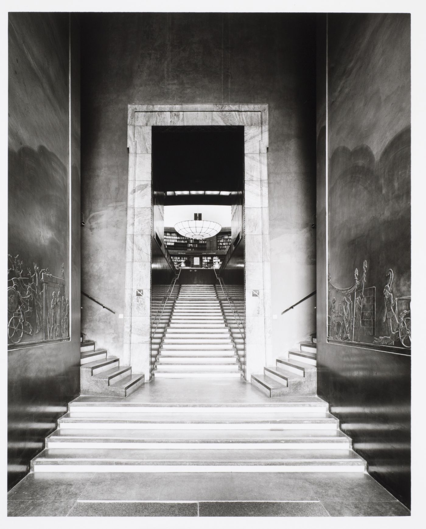 Interior view of the stairs leading from the lobby to the lending hall of Stockholm Public Library showing the bas-reliefs depicting scenes from the Iliad sculpted by Ivar Viktor Johnsson, 51-55 Odengatan, Stockholm, Sweden