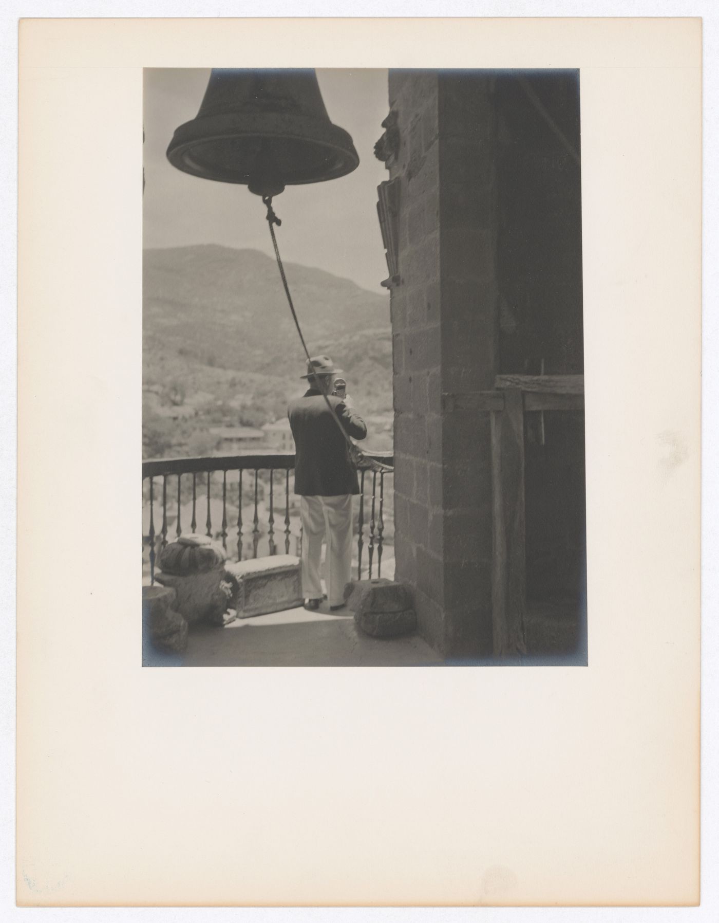 View of Harold standing in the bell tower of Santa Prisca with hills in the background, Taxco de Alarcón, Mexico