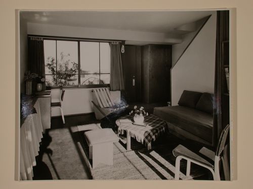 Interior view of a furnished living room in a two storey duplex