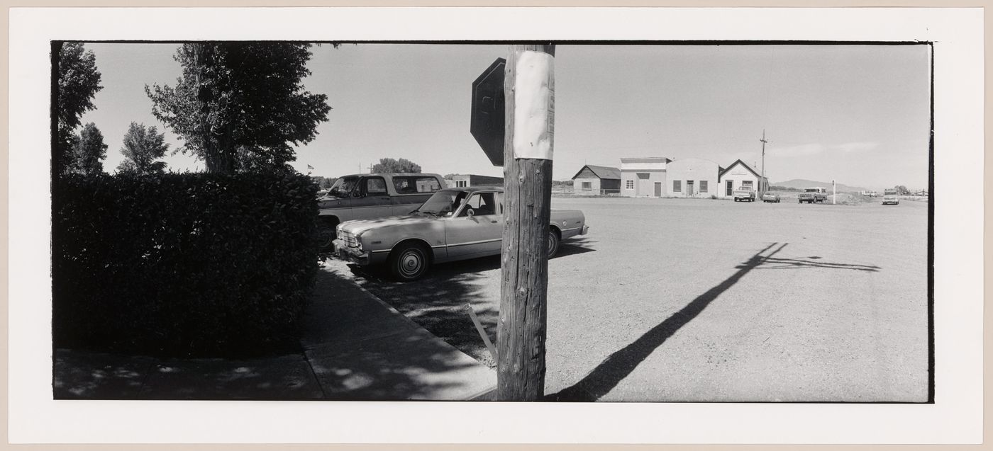 Panoramic view of the Courthouse Plaza showing parked cars and buildings with a utility pole in the foreground, Conejos, Colorado, United States