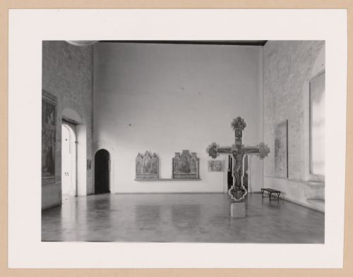 Interior view of a gallery showing a freestanding painted crucifix and paintings, Palazzo Abatellis, Galleria regionale della Sicilia, Palermo, Italy