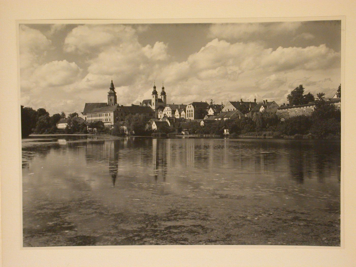View across Ulický Pond towards Telc showing St. James Church and the Church of Jesus' Name, Czechoslovakia (now Czech Republic)