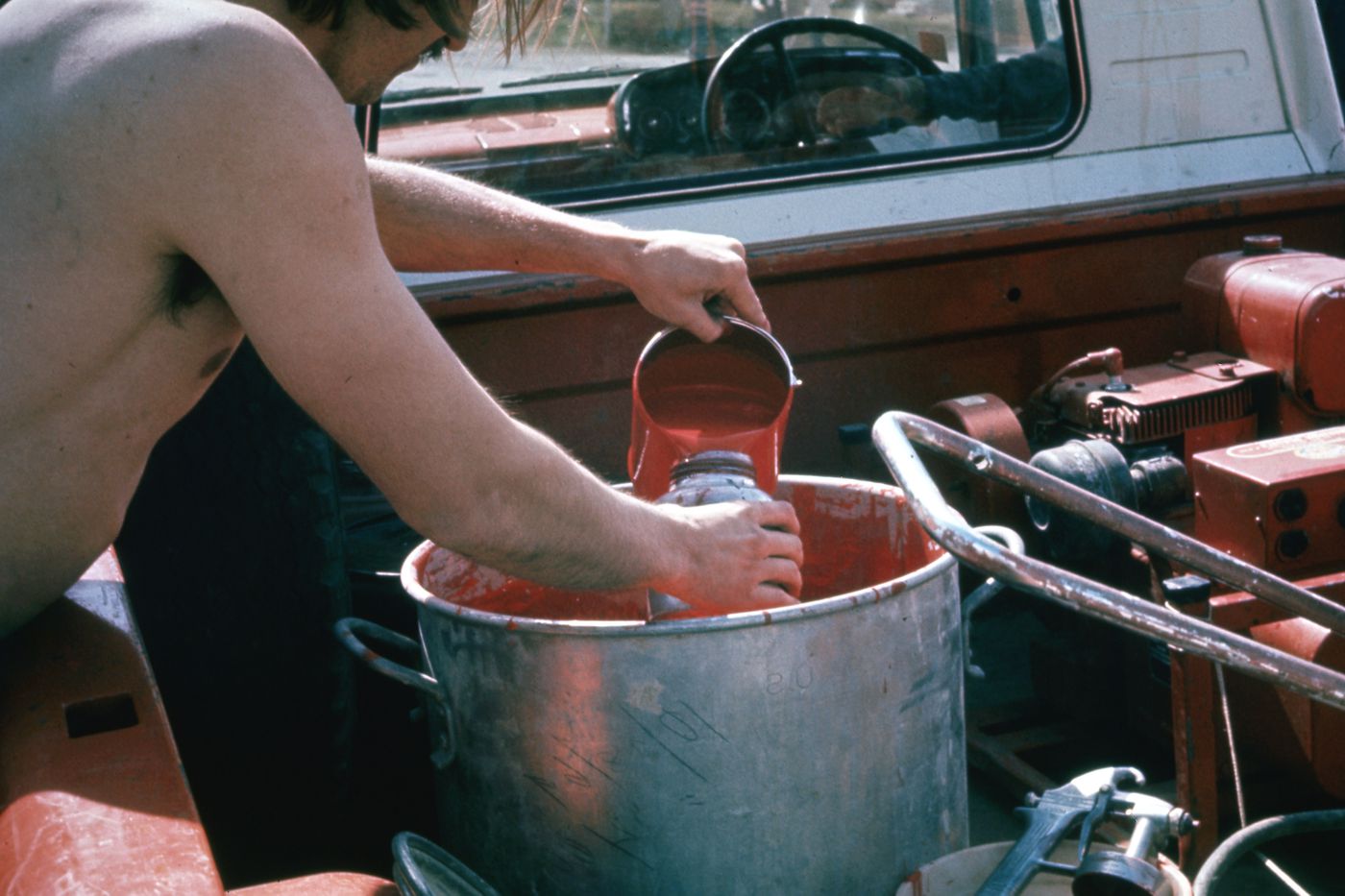 Picture of student pouring red paint for performance of Red Line