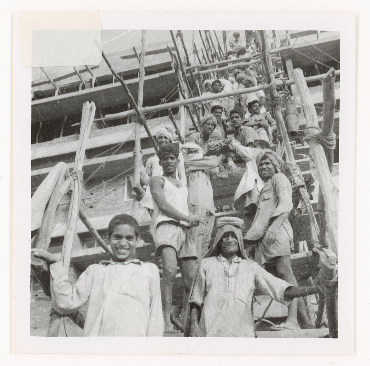 Portrait of construction workers passing on material supplies to upper levels of building, Chandigarh, India