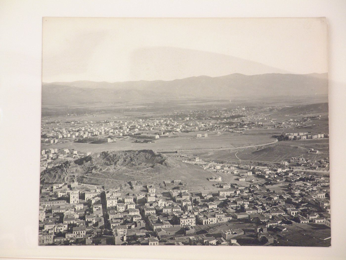 Aerial view of an unidentified city with mountains in the background