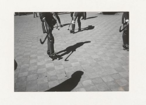 View of people playing ball hockey with shadows, South America