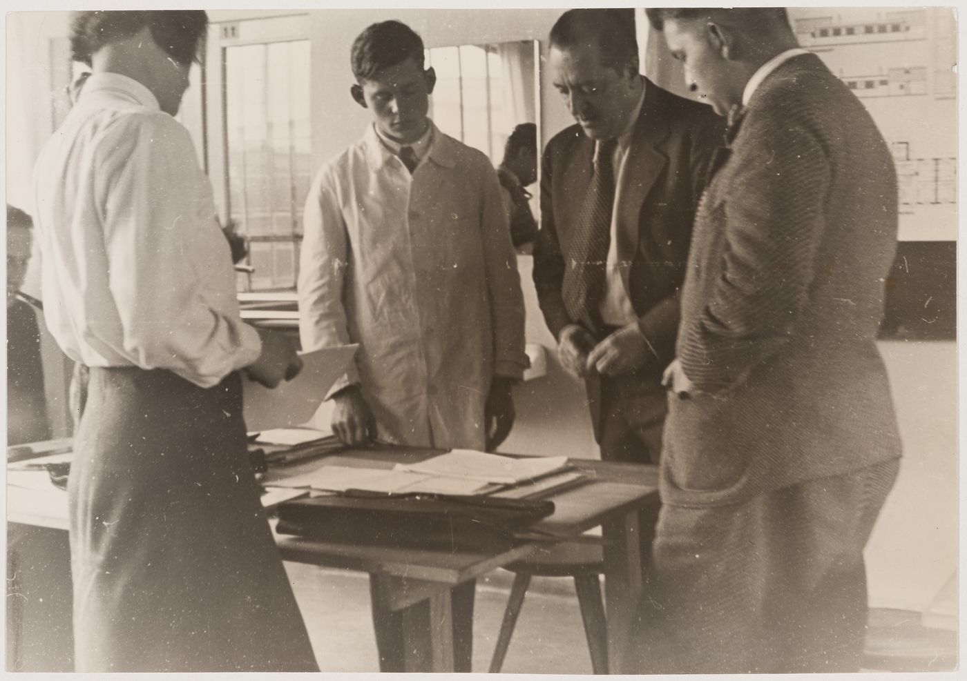 Mies van der Rohe conducting a seminar at the Bauhaus with students Annemarie Wilke, Heinrich Neuy and Herman Klumpp, Dessau, Germany