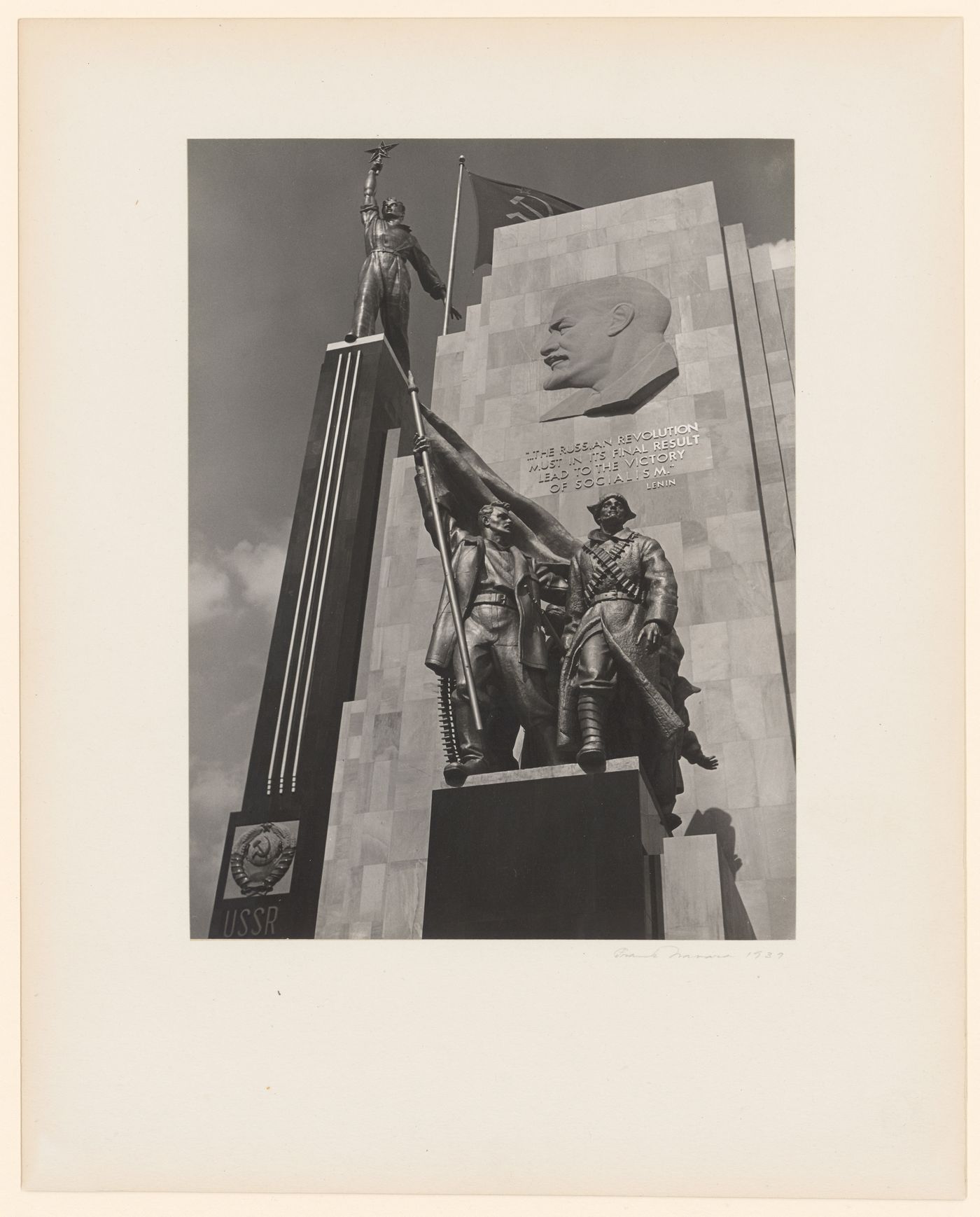 Partial view of the principal façade of the Soviet Pavilion at the New York World's Fair (1939-1940), showing a bas-relief of Lenin and statues of workers and a soldier, New York City