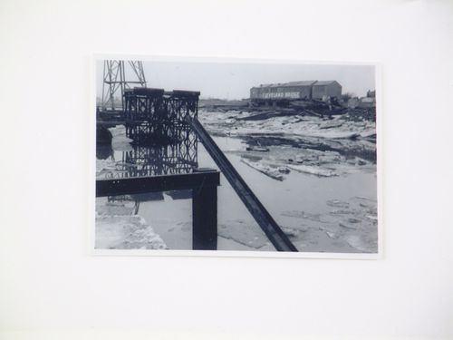 View of building labelled "Cleveland Bridge," steel beams, ice and water