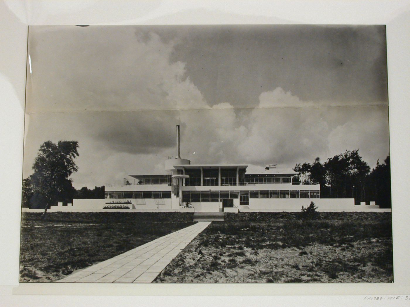 View of sanatorium "Zonnestraal" central-services building showing chimney tower, front yard and path, Hilversum, The Netherlands
