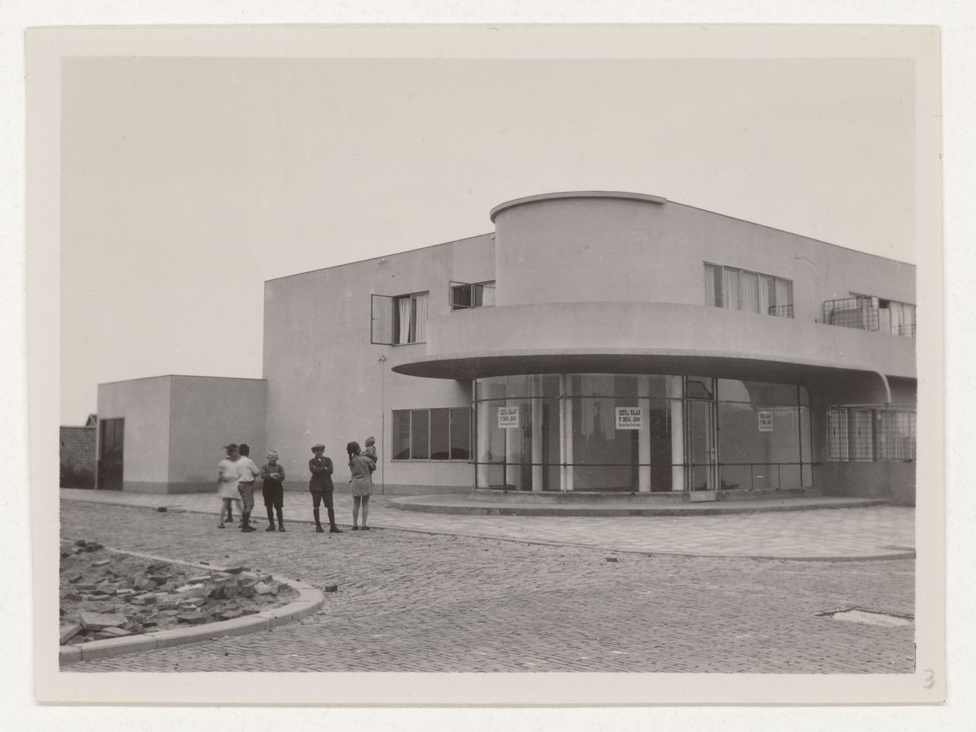 Exterior view of industrial row houses showing a corner store, Hoek van Holland, Netherlands