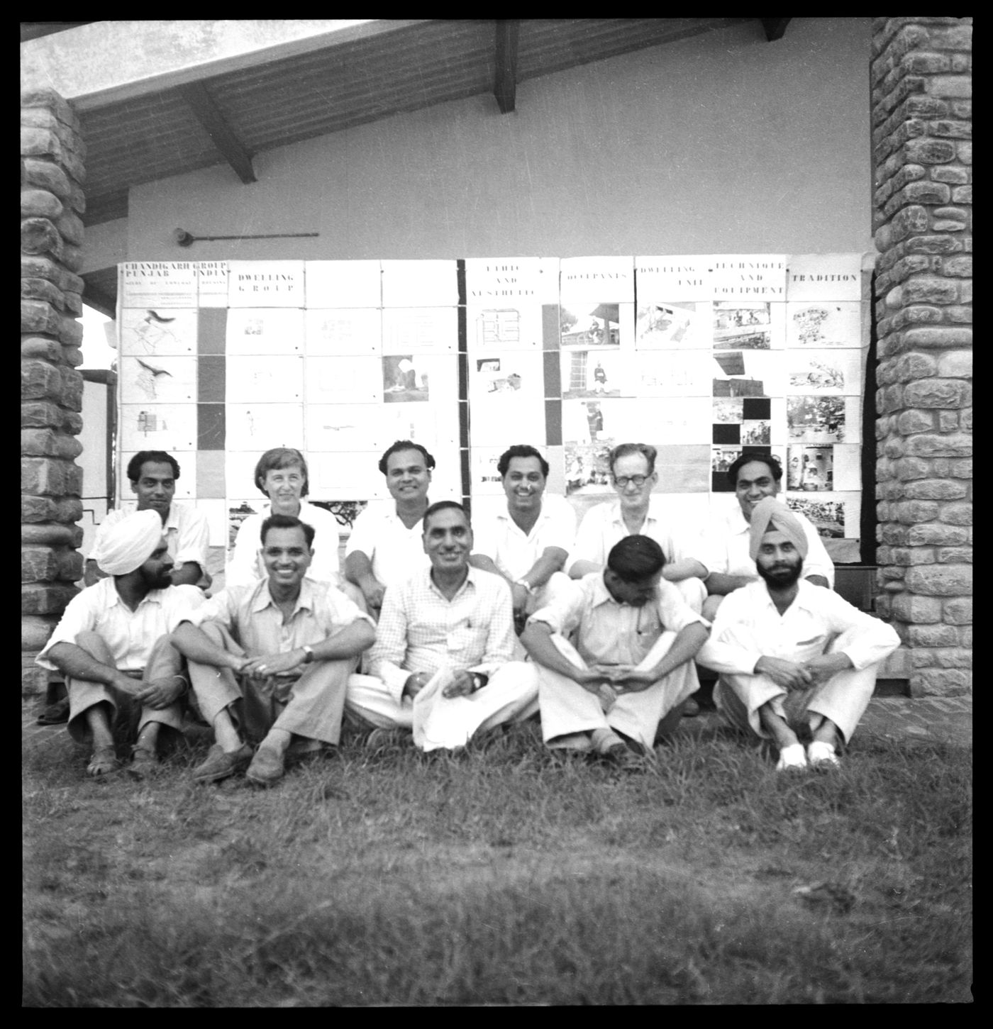 Architects' Office group portrait picturing Jane Drew (back row, second from left) and Maxwell Fry (back row, second from right) in front of the Chandigarh grid, at the Architect's Office, Sector 19, Chandigarh, India