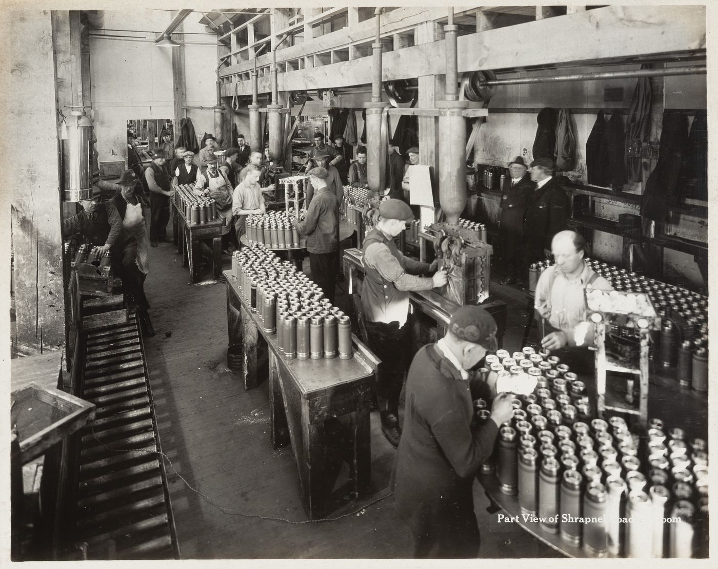 Interior view of workers in shrapnel loading room at the Energite Explosives Plant No. 3, the Shell Loading Plant, Renfrew, Ontario, Canada