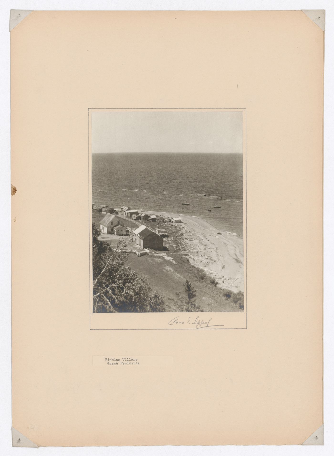 Partial view of a fishing village showing houses and sheds with the Saint Lawrence River [?] in the background, Gaspé Peninsula, Québec, Canada