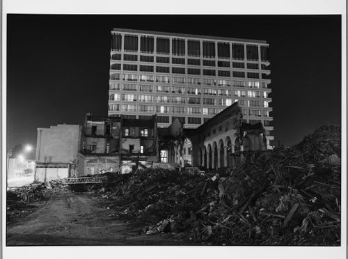 Partially demolished building, and rubble in front of contemporary building, Pasadena, California