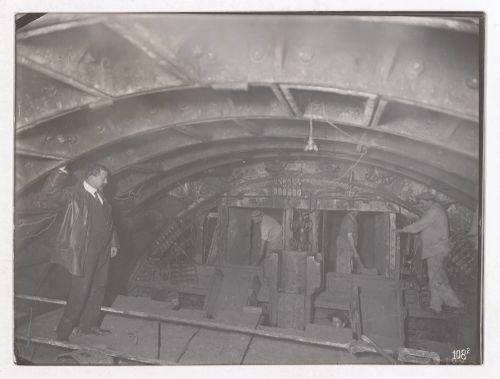 Construction of the Paris Metro, interior view with workers in a room with a low ceiling, Paris, France