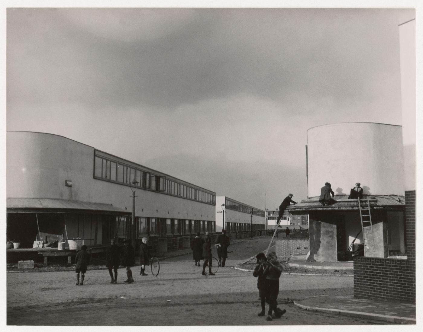 Exterior view of Kiefhoek Housing Estate showing corner stores under construction, Rotterdam, Netherlands