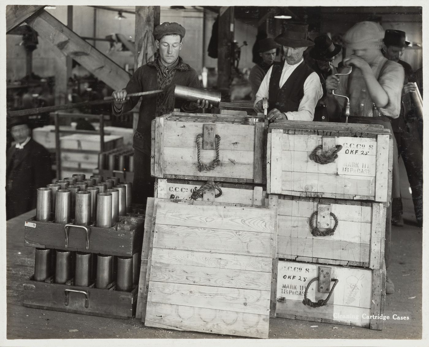 Interior view of workers cleaning cartridge cases at the Energite Explosives Plant No. 3, the Shell Loading Plant, Renfrew, Ontario, Canada