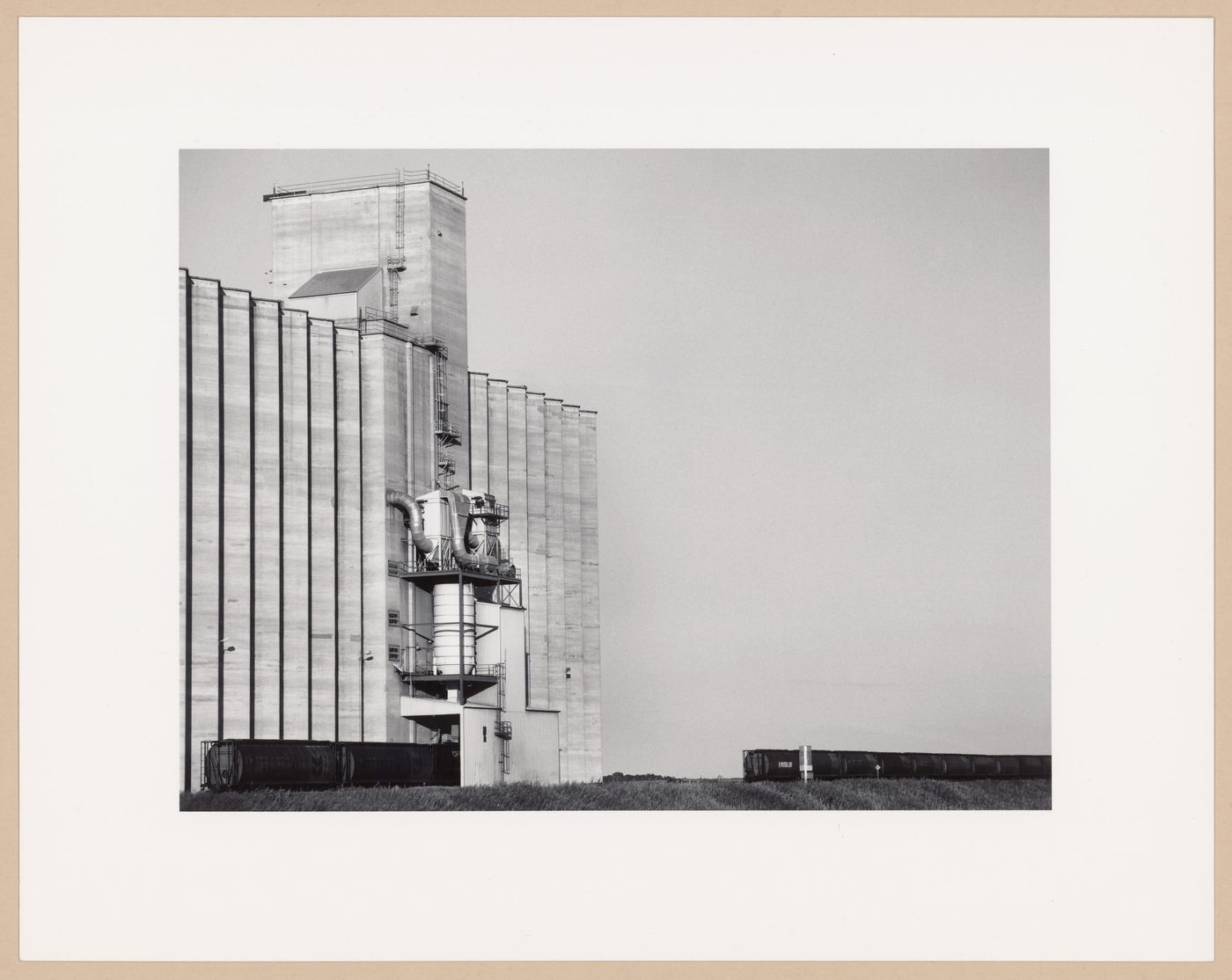 Modern grain elevators and train, Weyburn Inland Terminals Ltd., Weyburn, Saskatchewan, from the series The Forms of Canadian Industrial Architecture