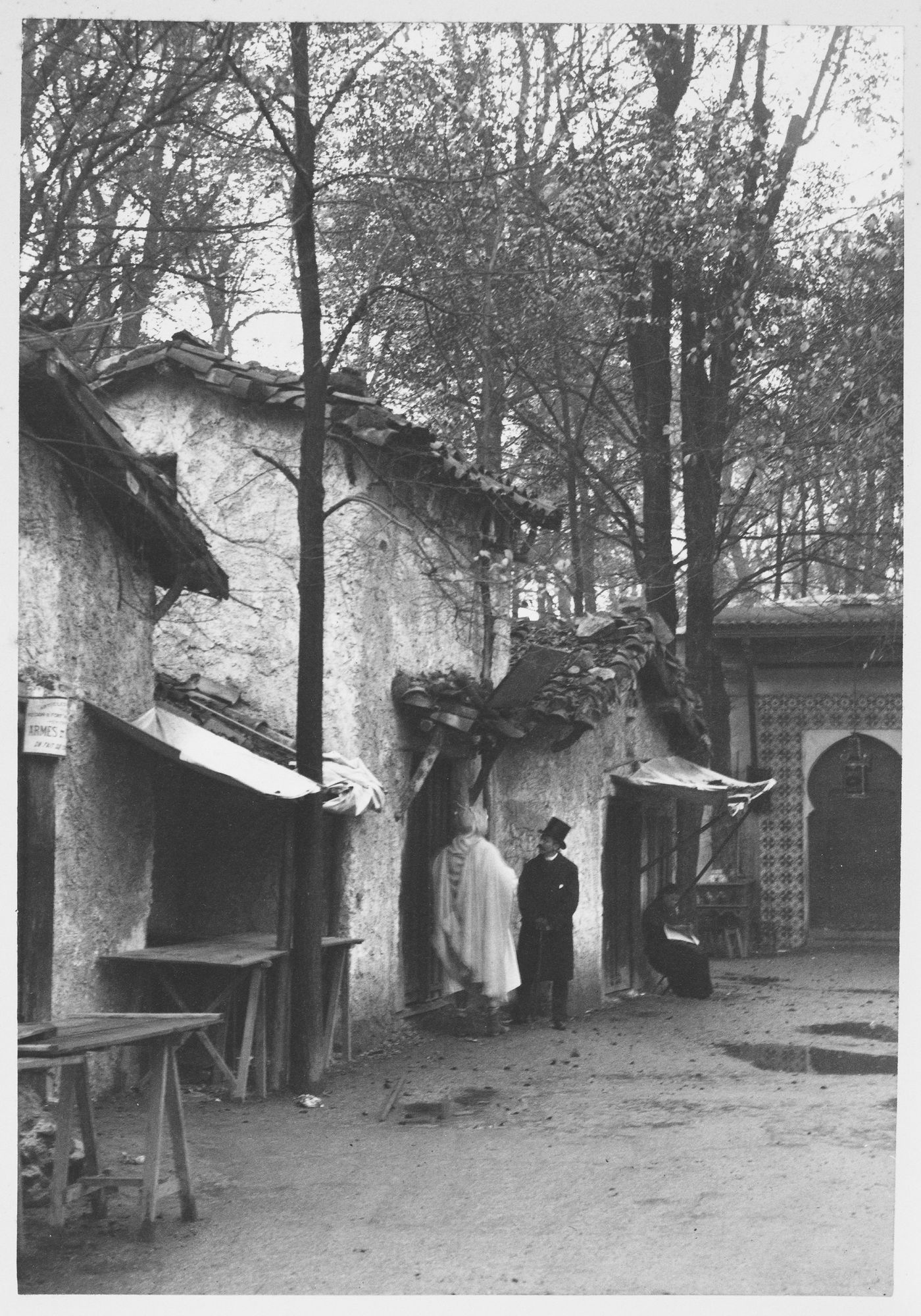 View of three people in front of the Kabyle house, part of the Pavillon de l'Algérie, Exposition universelle de 1889, Paris, France