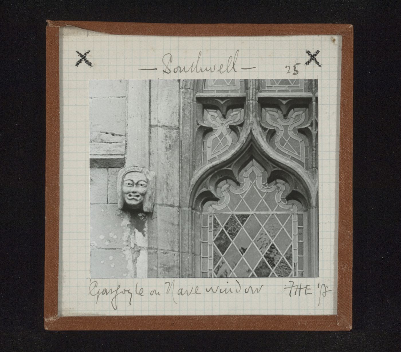 View of sculpture of head and partial view of stained glass window of nave, Southwell Minster, Southwell, Nottinghamshire, England