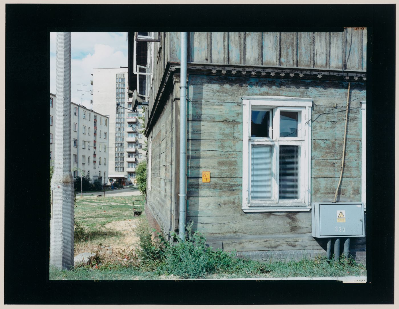 View of a wooden house and apartment houses, Malbork, Poland