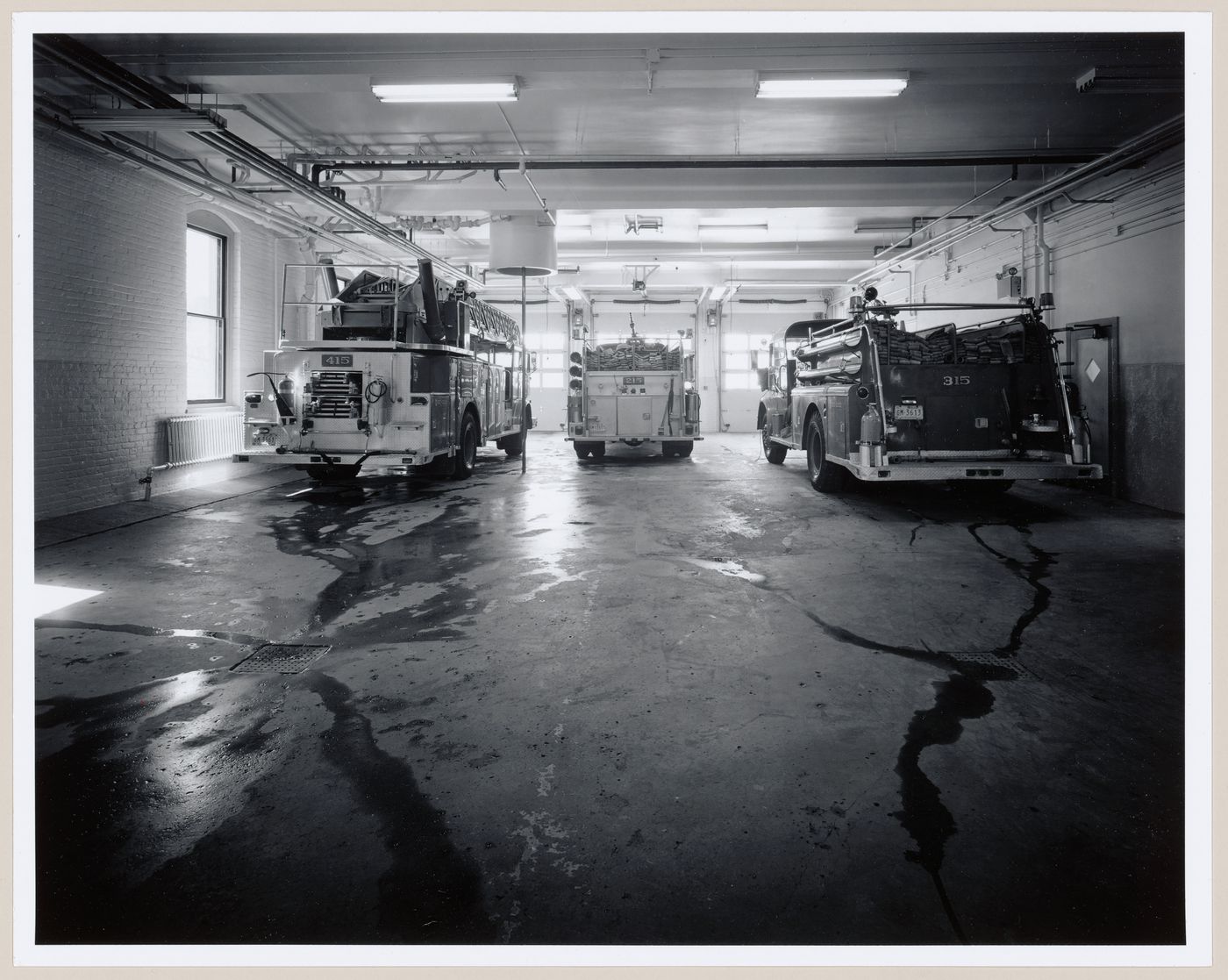 Interior view of the main floor of Fire Station no. 15 showing firetrucks, Richmond Street, Montréal, Québec