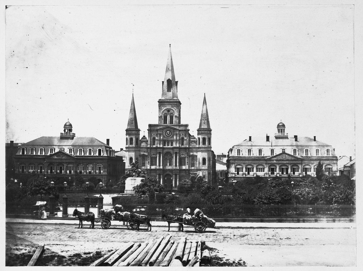 View of St. Louis Cathedral from street, horse carts in front, New Orleans, Louisiana