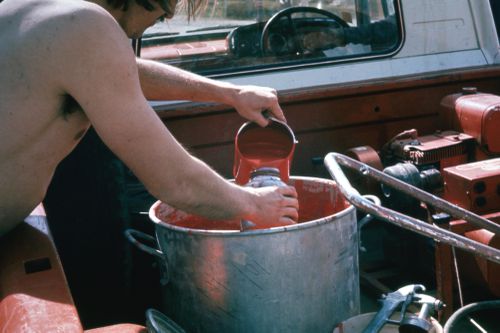 Picture of student pouring red paint for performance of Red Line