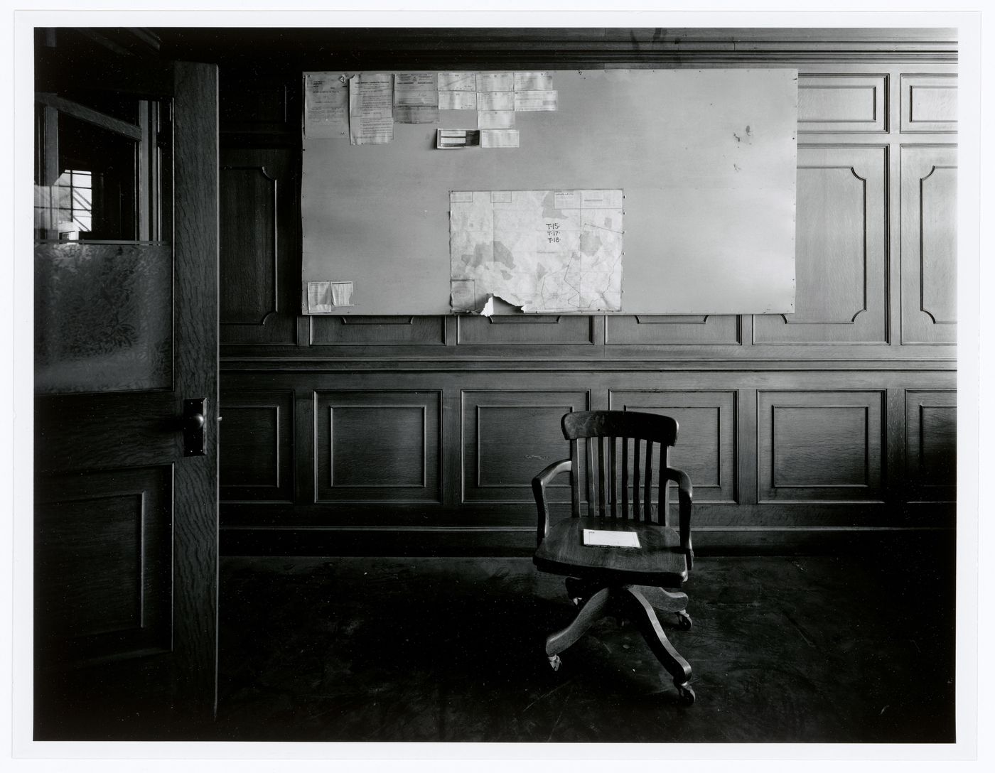 Interior view of an office on the second floor of the administration building of the Belding Corticelli Spinning Mill showing a chair and bulletin board, Montréal, Québec