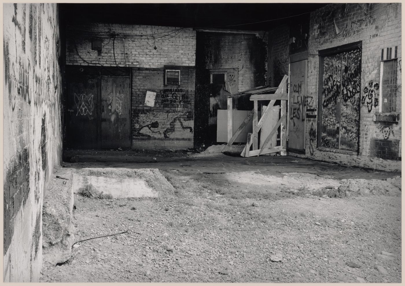 Field Work in Montreal: View of a wooden shack-like structure, brick walls, doorways and graffiti, Montréal, Québec