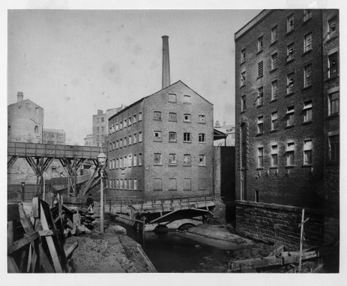 View of footbridge over the river Irk and School Mills, Manchester, England