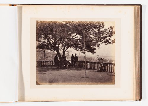 View of men sitting at an overlook with the city and the Bosporus in the background, Constantinople (now Istanbul), Ottoman Empire (now in Turkey)