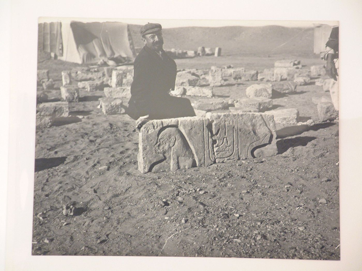 Men sitting on a stone with hieroglyphics, Egypt