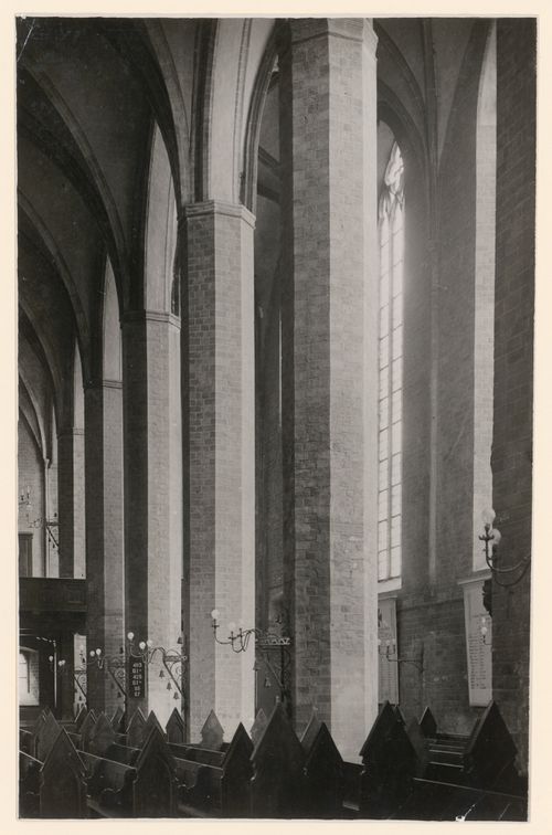 Interior, detail of tall masonry piers and lower portions of vaults, with pews in foreground, Brandenburg, Germany