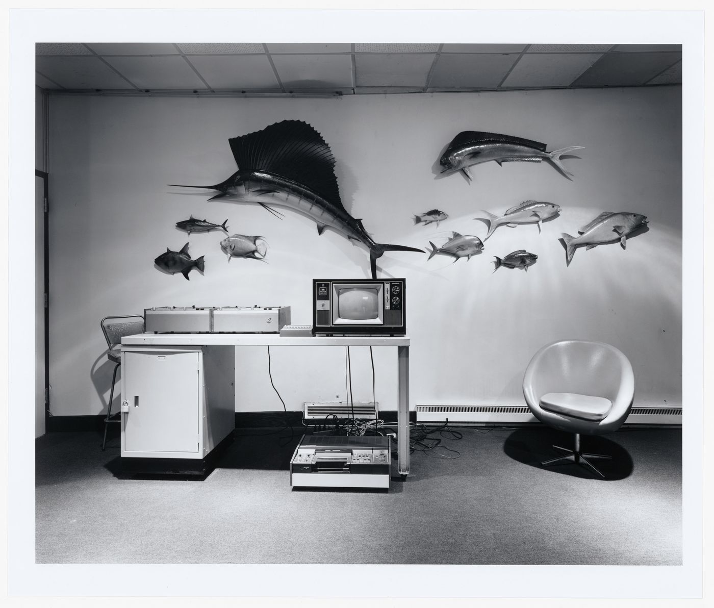 Recording Studio, carpeted room with table, recording equipment, chair and plastic fish on the wall, Reading, England