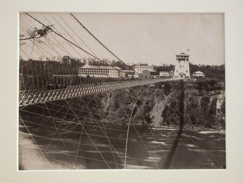 Niagara Suspension Bridge over the Niagara River showing tower at one end and people crossing, Niagara Falls, New York
