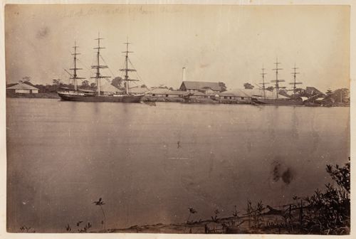 View of a harbour, ships and a rice mill, Bassein, Burma (now Myanmar)