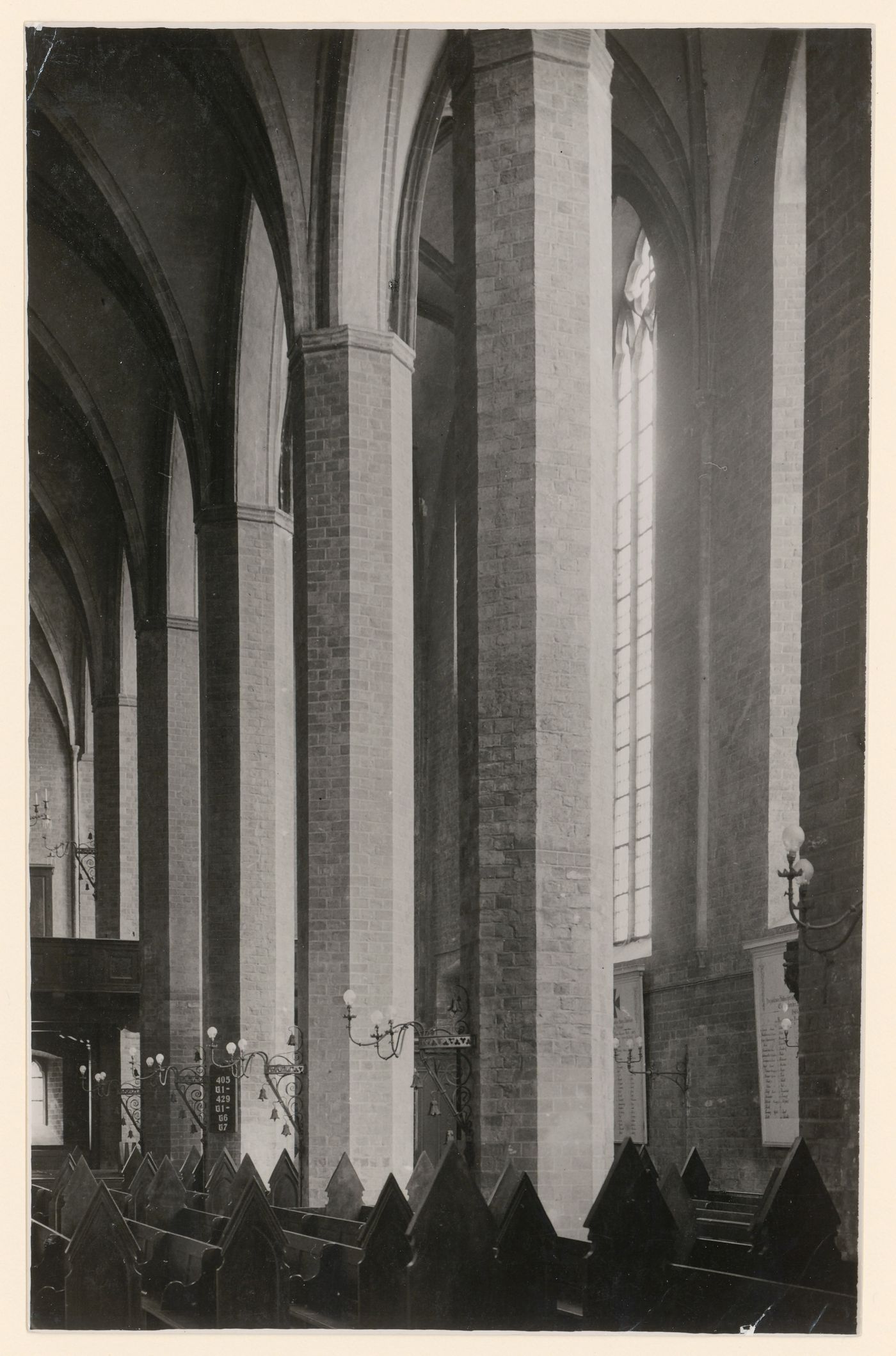 Interior, detail of tall masonry piers and lower portions of vaults, with pews in foreground, Brandenburg, Germany