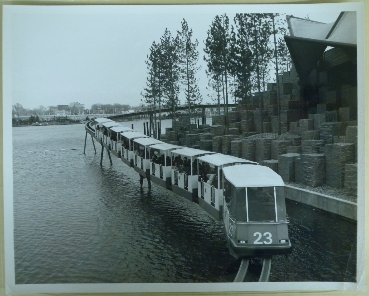 View of the minirail above water near the granite base of the Ontario Pavilion, Expo 67, Montréal, Québec
