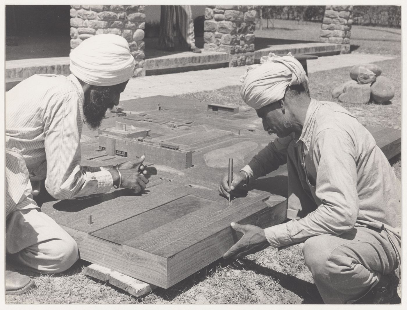 Portrait of model makers, Rattan Singh and Dhani Ram, at work on the model for Capitol Complex, Sector 1, Chandigarh, India